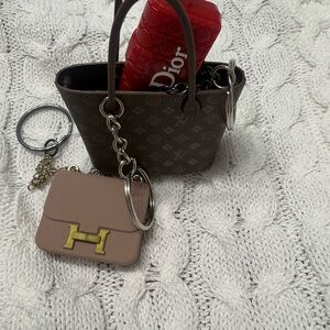 Louis Vuitton, Hermes, and Dior fashion keychains.